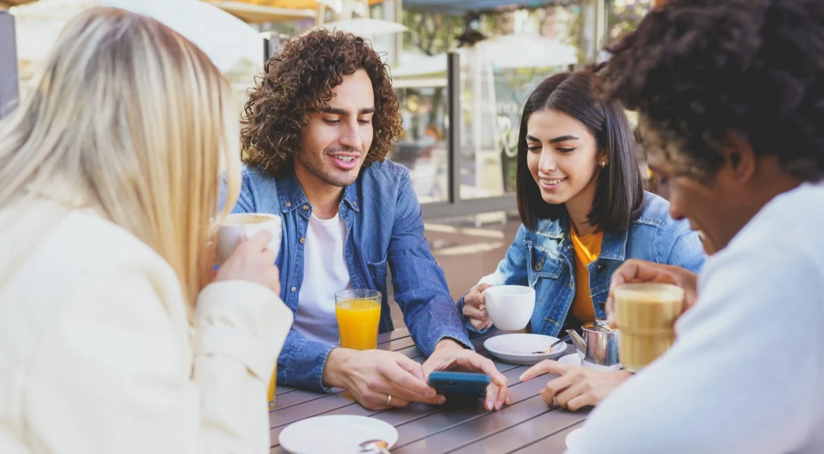 A group of friends looking at a phone